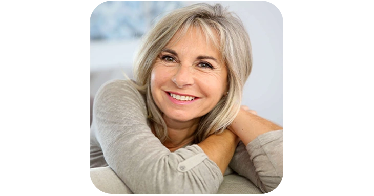 Trimology smiling mature woman customer sharing positive results and natural vitality after taking the daily metabolic support supplement.